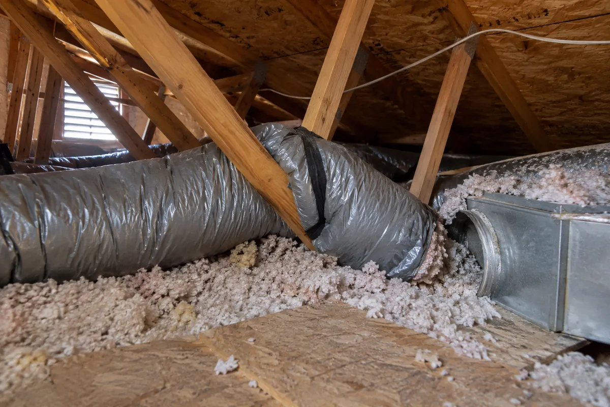 Attic with flexible ducts and blown-in insulation under the rafters, duct repair and sealing in Garland, TX
